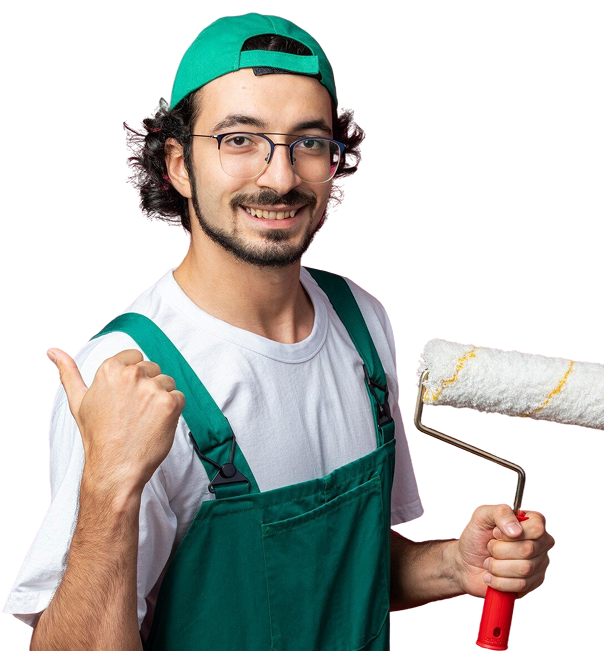 smiling young builder man wearing uniform with cap holding roller brush showing thumb up 1